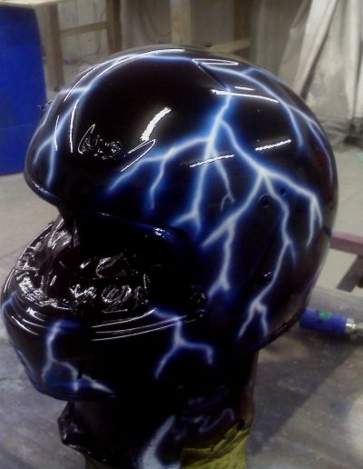A custom painted motorcycle helmet with lightning bolts