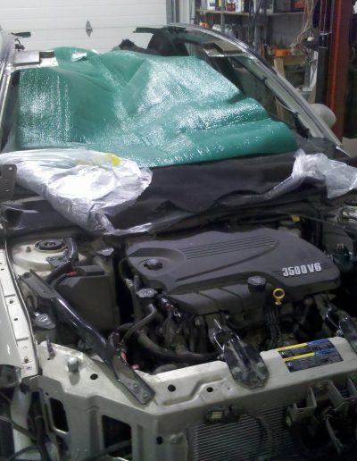 A silver Chevy being repaired at Blackburn Collision Center
