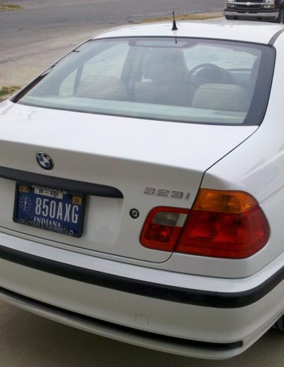 A recently repaired white BMW