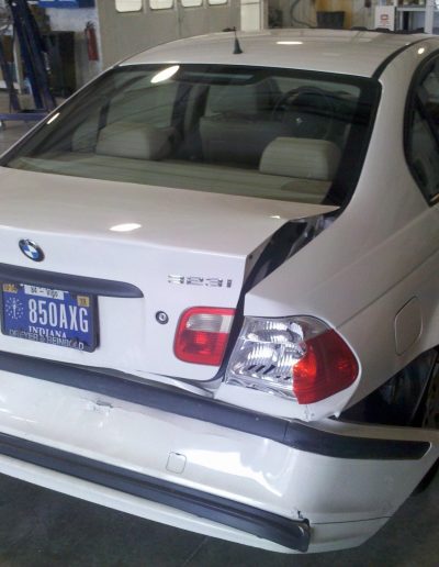 A white BMW that has been rear-ended